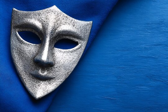 Silver Mask on Blue Background.