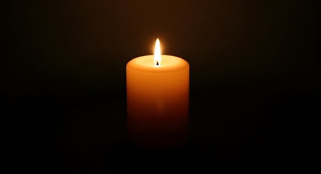 A single lit candle in the darkness