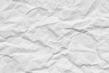 Fototapeta premium White Crumpled Paper Texture Background,Top view of a blank white sheet of crumpled paper. The surface is covered in random folds, creases, and wrinkles, creating a high-contrast textured background. 