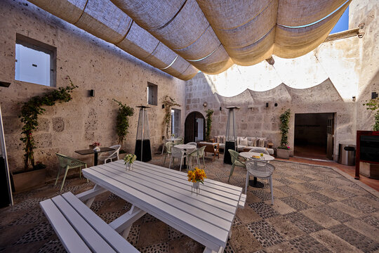 Stepping back in time, a sunlit courtyard of a centuries-old colonial sillar stone residence in Arequipa, Peru, reveals the enduring soul of the "White City." Worn volcanic ashlar blocks frame a grace