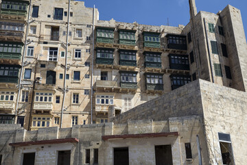 Fototapeta premium 2019 Valletta - tall old tenement houses with traditional balconies in the old town