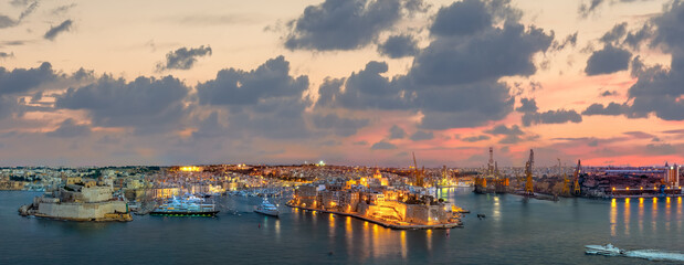 Scenic night view of Grand Harbour, port and fortress. Valletta, Malta