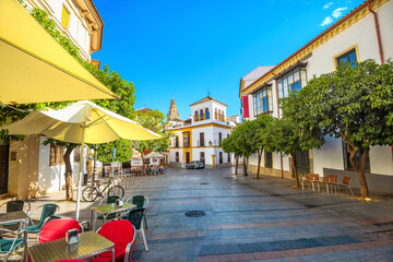 Typical street with outdoors cafe in old historical district in Cordoba. Andalusia, Spain