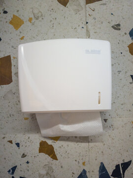 Votkinsk, Russia - February 25, 2026: Thermal complex "Teplaya volna". White paper towel dispenser mounted on wall with paper towel partially pulled out in commercial restroom