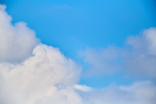 Close-up of blue sky with huge white clouds