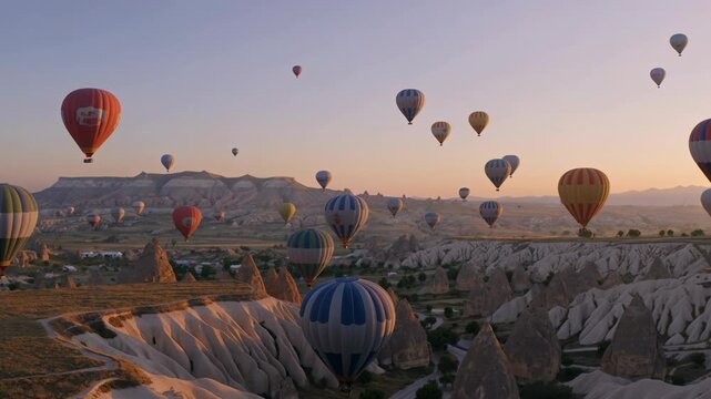 Hot Air Balloons Soaring Over Cappadocia's Unique Rock Formations at Sunrise, Turkey. Breathtaking Scenic Landscape.