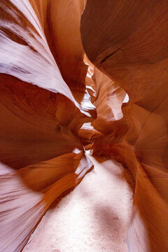 View of sculpted sandstone walls create a stunning natural cathedral of light and shadow, revealing the earth's artistry in a symphony of textures, Page, Arizona, United States.