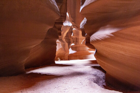 View of sandstone walls curve and twist in a mesmerizing dance of light and shadow, creating a surreal, otherworldly landscape, Page, Arizona, United States.