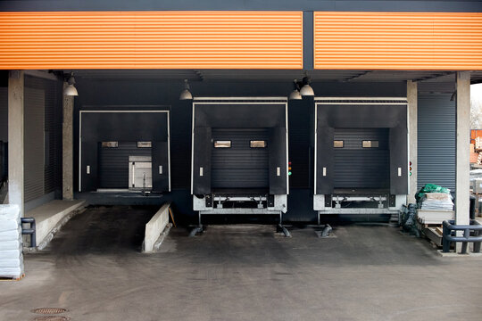 Loading dock or loading bay with bumpers, levelers, lift, dock seals or shelters, traffic lights. Loading bay is area of building where goods vehicles road or rail are loaded and unloaded.