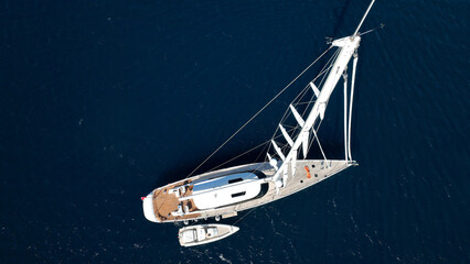 Aerial drone photo of beautiful sail boat anchored in deep blue Aegean Sea © aerial-drone