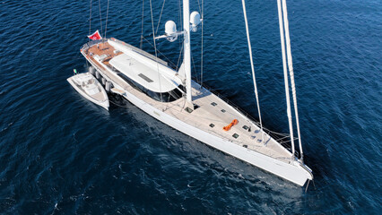 Aerial drone photo of beautiful sail boat anchored in deep blue Aegean Sea © aerial-drone