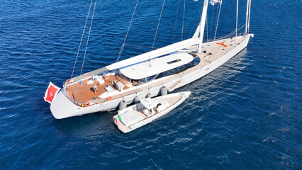 Aerial drone photo of beautiful sail boat anchored in deep blue Aegean Sea © aerial-drone