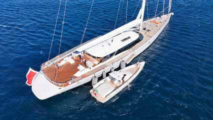 Aerial drone photo of beautiful sail boat anchored in deep blue Aegean Sea © aerial-drone