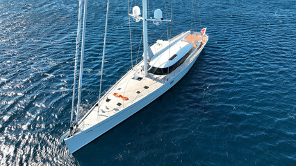 Aerial drone photo of beautiful sail boat anchored in deep blue Aegean Sea © aerial-drone