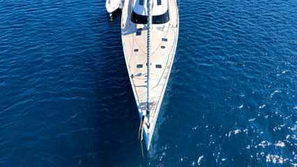 Aerial drone photo of beautiful luxury sail boat with wooden deck anchored in deep blue Mediterranean sea  © aerial-drone