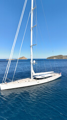 Fototapeta premium Aerial drone photo of beautiful sail boat anchored in deep blue Aegean Sea