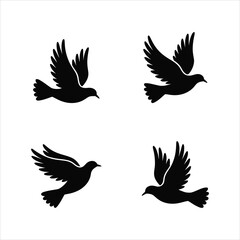 Fototapeta premium Four black silhouette doves in flight on a white background, symbolizing peace and freedom.