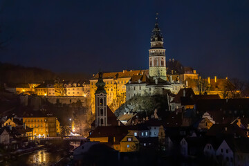 Fototapeta premium Cesky Krumlov castle and Saint Vitus church illuminating cityscape at night
