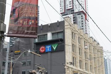 Obraz premium pole mounted banner for Queen Street West with defocused view of CTV and Bell Media building at 299 Queen W, Toronto