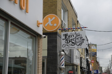 Fototapeta premium wall mounted projecting sign of Tony's Barber Shop located at 1649 Bayview Av, East York, Toronto