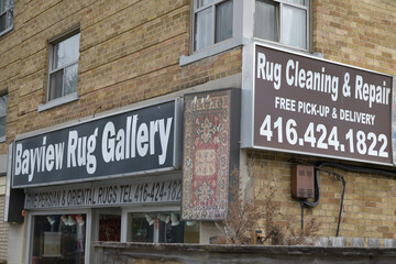 Fototapeta premium exterior building and signage outside Bayview Rug Gallery, a carpet cleaning service, located at 1215 Bayview Av, Toronto