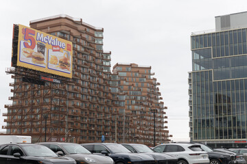 Obraz premium McDonald's Canada roadside billboard advertising for McValue meal, near Queens Quay E with view of Aqualuna Condos, Toronto