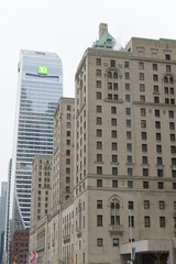 Obraz premium looking west on Front St W from Bay St to Fairmont Royal York hotel and TD Terrace a corporate office tower, Toronto