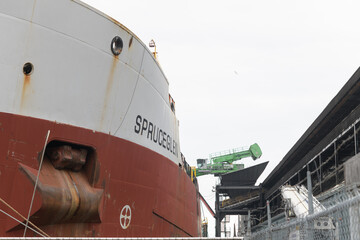 Fototapeta premium Spruceglen, a bulk carrier, owned by Canada Steamship Lines (CLS), at Redpath Sugar Refinery, docked at Lower Jarvis St slip, Toronto