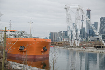 Fototapeta premium view of MV Tamarack (Canada Steamship Lines), a cement carrier, docked at Polson slip (Amrize, formerly Lafarge), from Cherry St, Port Lands, Toronto