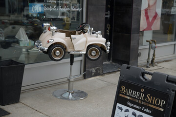 Fototapeta premium novelty child's chair outside The Ritz Men's Haircut, a barber shop, located at 1693A Bayview Av, East York, Toronto