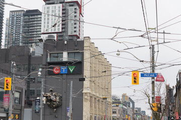 Fototapeta premium east facing side of 299 Queen St W, Bell Media headquarters, at McCaul St, with overhead transit wires, Toronto