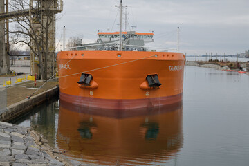 Fototapeta premium view of MV Tamarack (Canada Steamship Lines), a cement carrier, docked at Polson slip (Amrize, formerly Lafarge), from Cherry St, Port Lands, Toronto