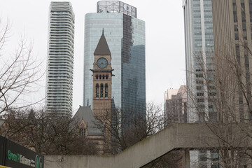 Fototapeta premium clock and bell tower of Old City Hall, contrasted with CF office tower and Massey Tower condo, viewed from west edge of Nathan Phillips Square, Toronto