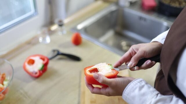 A female cook chopping vegetables in the kitchen