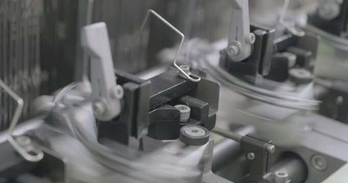 Spinning equipment, weaving machine, the jacquard loom is working. The parts of the mechanism move rhythmically, performing reciprocating movements. Close-up handheld shot, real time speed.