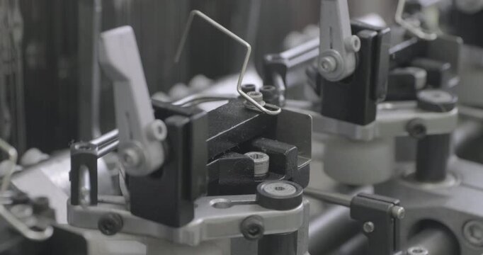 Spinning equipment, weaving machine, the jacquard loom is working. The parts of the mechanism move rhythmically, performing reciprocating movements. Close-up handheld shot, real time speed.