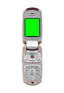 Silver flip mobile phone with green screen isolated on white background.