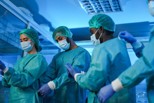 Medical people prepare for operation inside hospital room - Surgery, multiracial team and healthcare concept