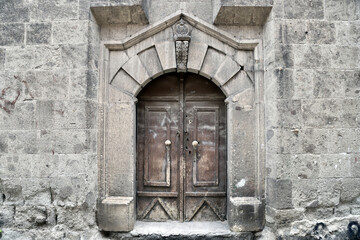 Fototapeta premium A detail of the door featuring an arched stone frame at Hoca Üveys Han in Afyonkarahisar
