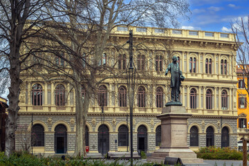 Fototapeta premium Palazzo De Toschi and monument in historic center of Bologna, Italy. Palace facade and bronze statue style