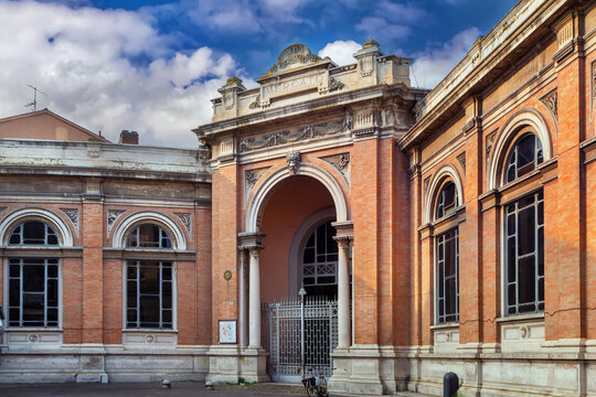 Facade and entrance gate of Mercato Coperto in Ravenna, Italy. Classical architecture and cloudy sky style