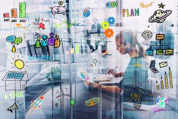 Professional woman works on business planning with digital sketches on glass walls in office during daytime