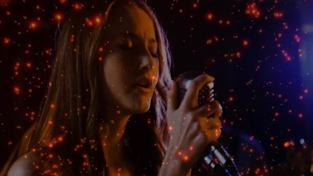 Lead singer bringing mic to mouth and singing in studio, sparking overlay with guitar for show