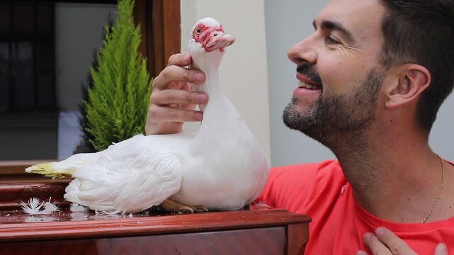 Adorable man with his domestic duck 