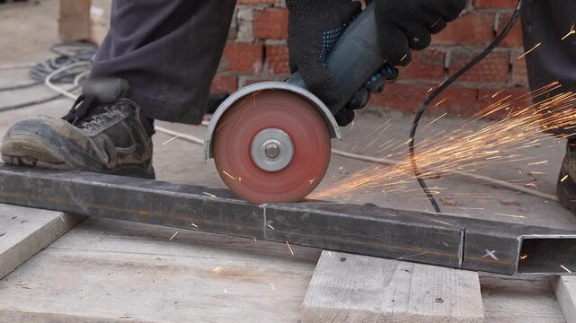 Worker Cutting Metal with Angle Grinder