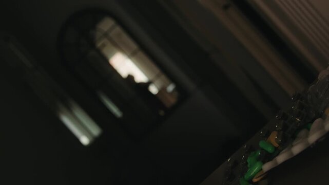 A silhouette of a woman pacing nervously, reflected in a mirror, with a stack of pills in the foreground. Conceptual representation of anxiety, stress, and mental health issues. High quality 4k