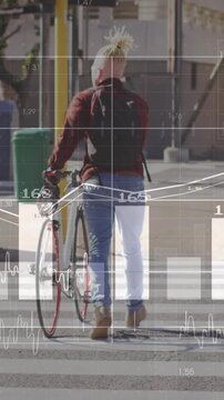 Vertical video: Man entering crosswalk, pushing bicycle while charts following him mapping commute
