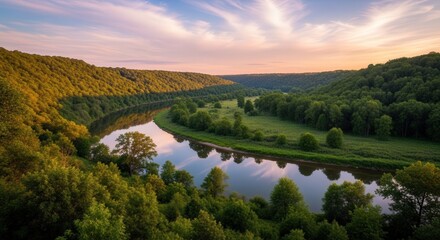 Obraz premium Serene River Landscape with Lush Green Forests and Rolling Hills at Sunset