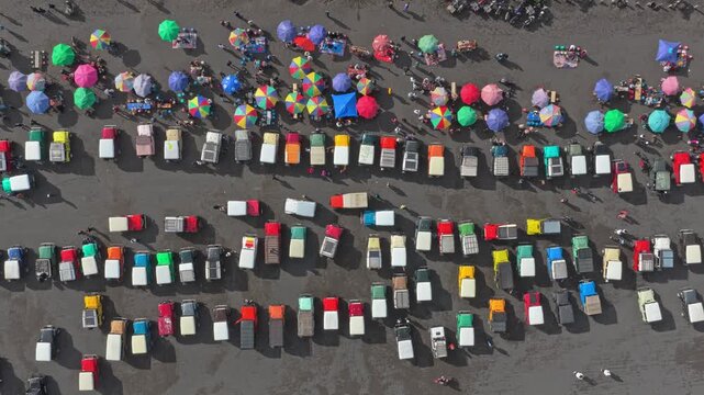 Aerial top down view of colorful jeeps in bromo tengger semeru national park