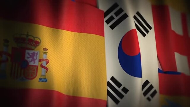 This features a close-up shot of the national flags of Spain, South Korea, and the United Kingdom waving together, conveying a sense of international unity and cooperation. The flags' vibrant colors